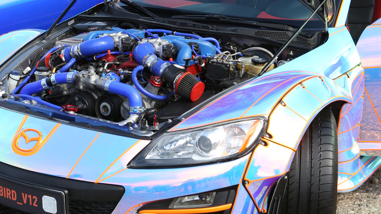 open engine bay of heavily modified and custom painted car