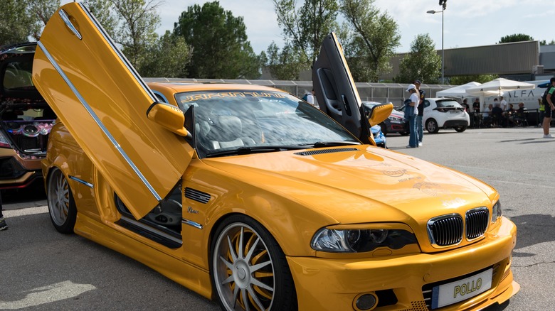 scissors doors are opened on a yellow BMW