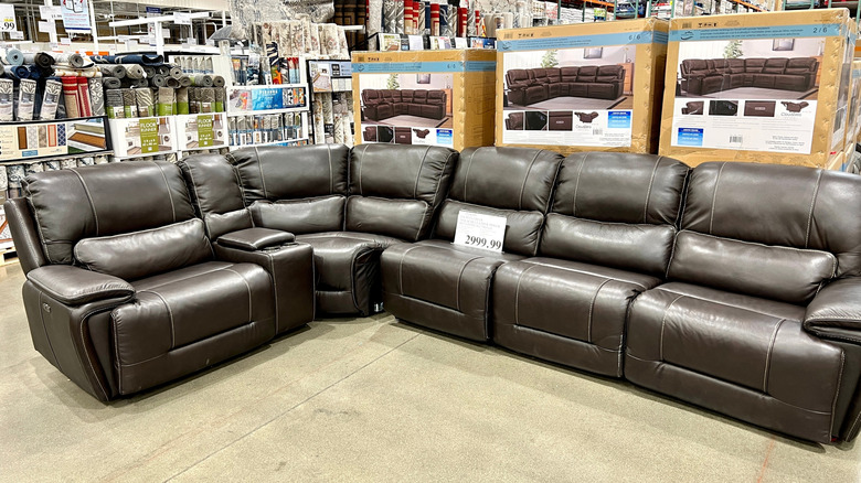 shaped reclining sofa on display inside a Costco warehouse.