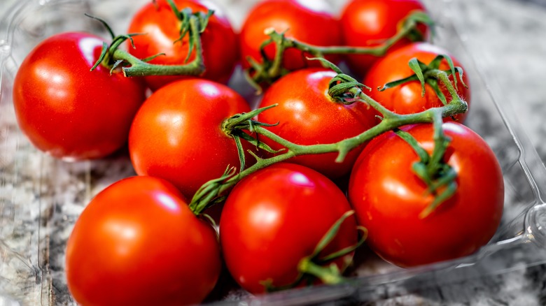Closeup macro of box of ripe red vine ripened campari tomatoes.