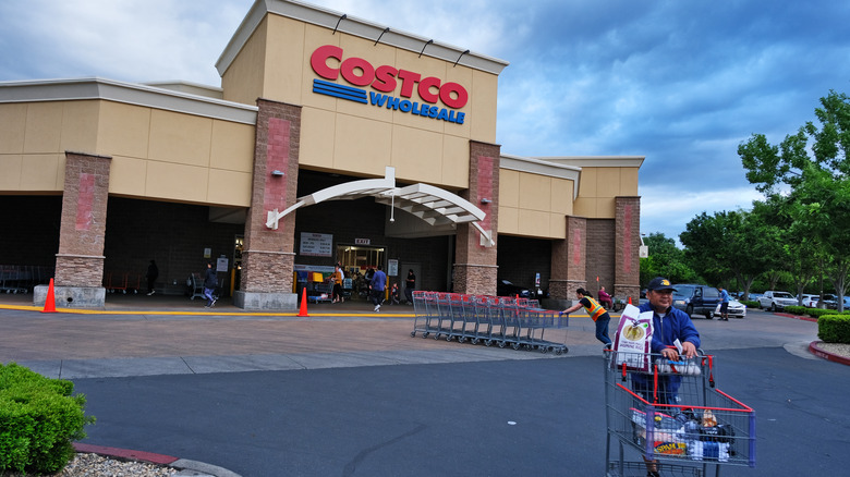 shoppers and staff in front of costco store