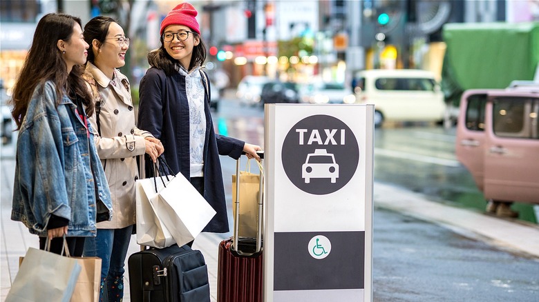 Travelers waiting at TAXI stop