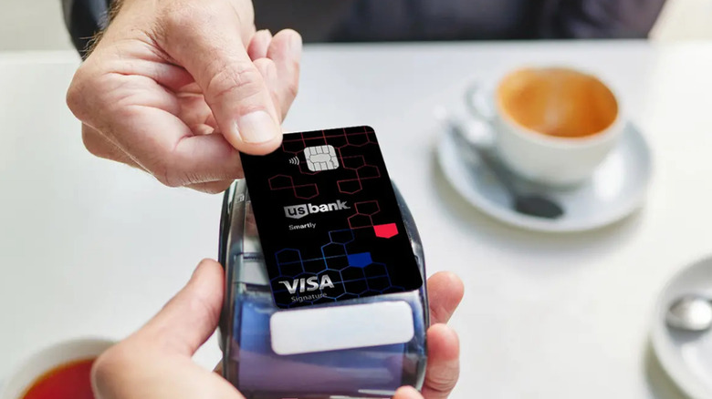 close-up of U.S. Bank Smartly Visa Signature Card being handed over