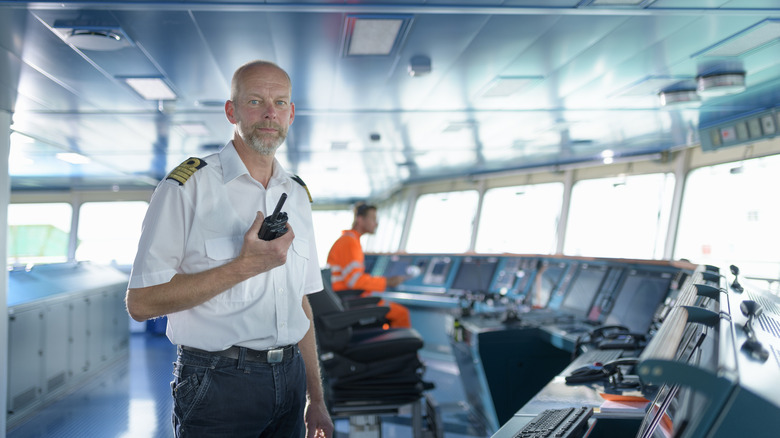 A ship's officer standing on the bridge