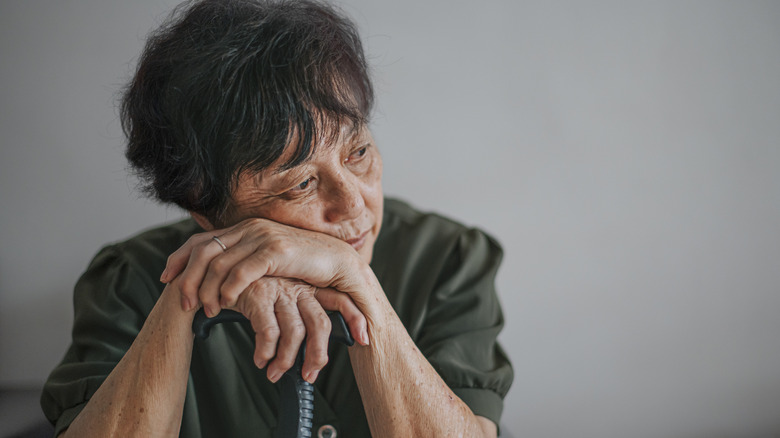 A mature woman looking despondent.