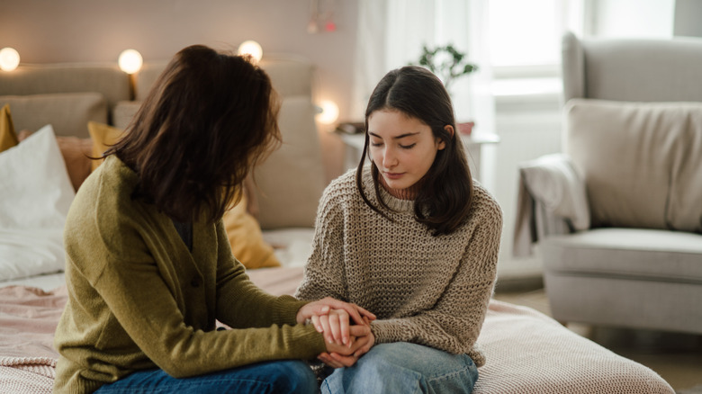 A young woman having a serious conversation with her mother.