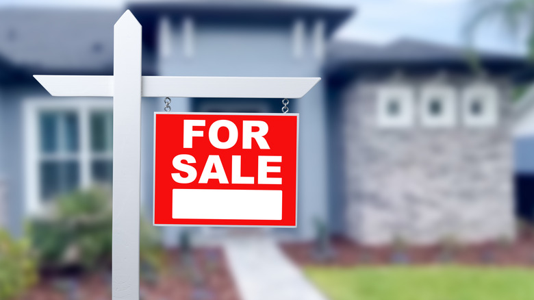 for sale sign in front of home