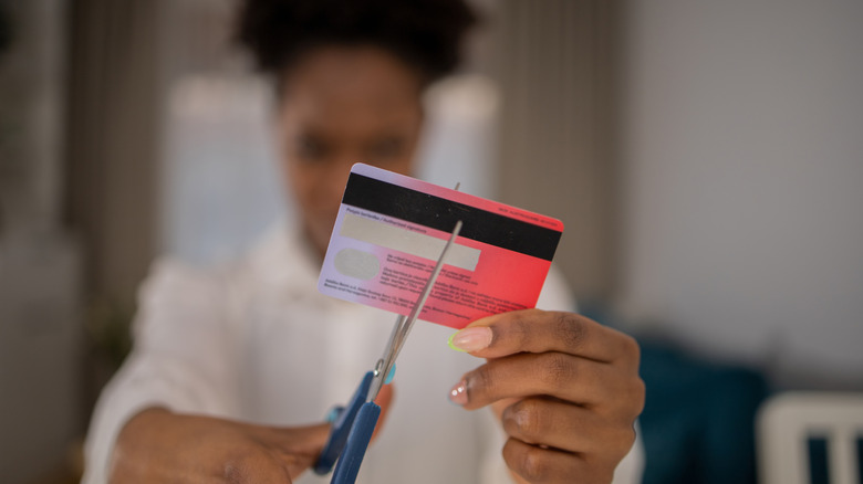 woman cutting up her credit card