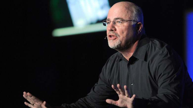 Dave Ramsey gestures while speaking on stage