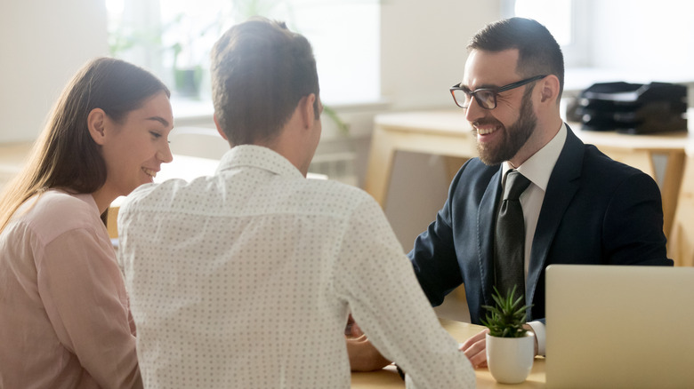 young couple making plans with a financial advisor