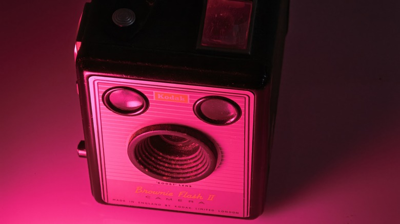 Kodak Brownie box camera shown in a pink light