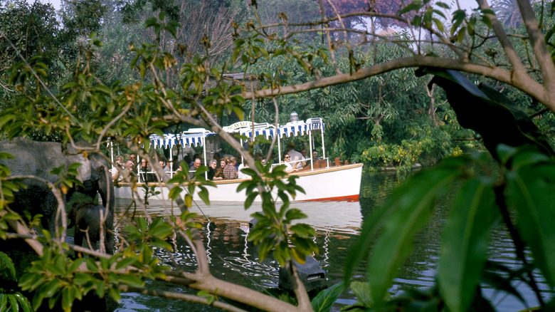 passengers ride a Disney jungle cruise boat