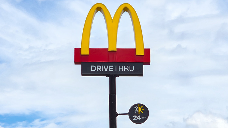 McDonald's sign outside of restaurant against blue sky