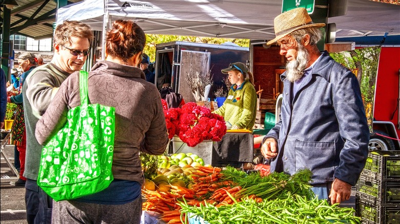Amish man selling vegetables
