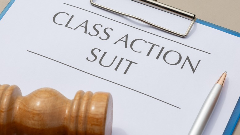 Class action document on wooden tabletop