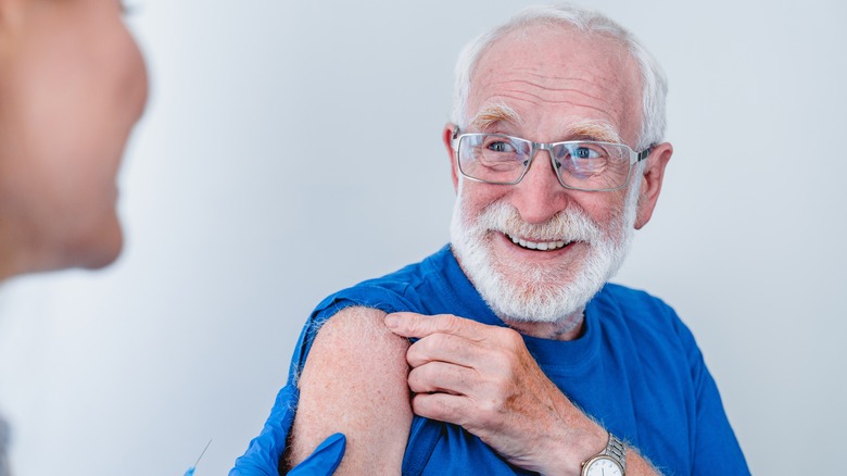 Elderly man receiving a Vaccine