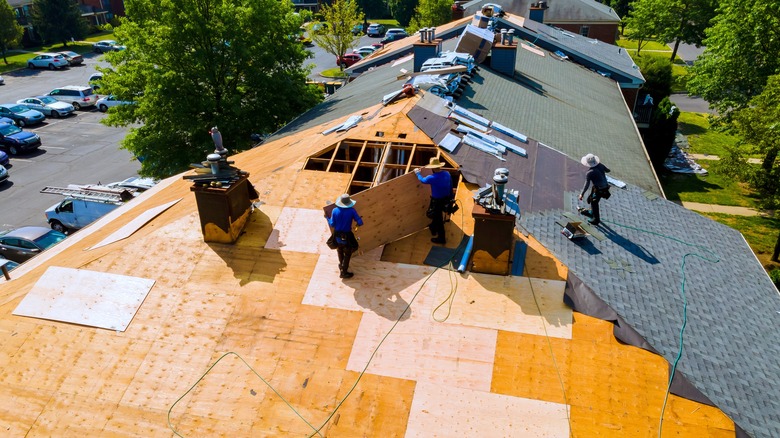 workers installing a whole new roof