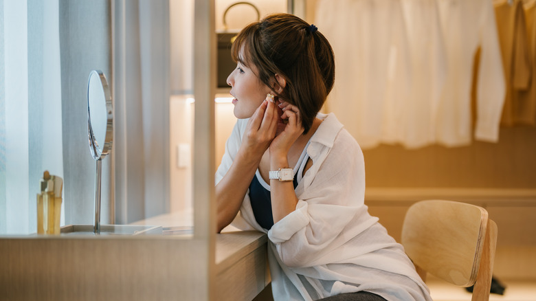 woman getting ready for the day in walk-in closet