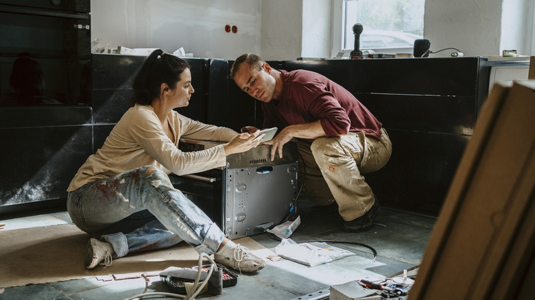homeowner working with contractor during a kitchen renovation