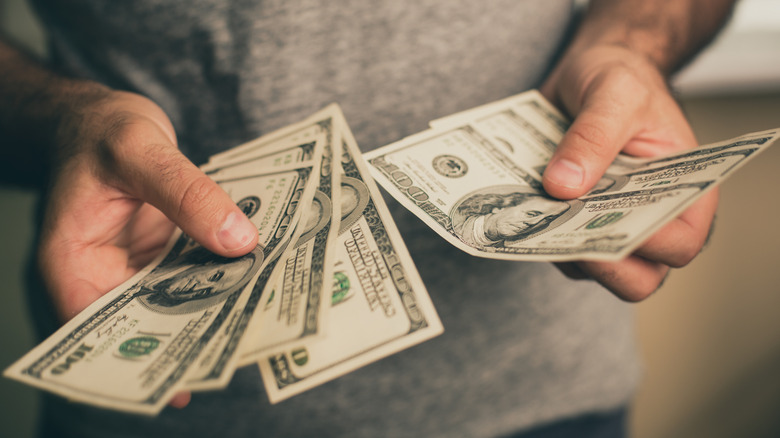 Person counting cash.