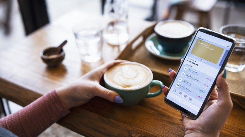 Women checking bank account on phone.