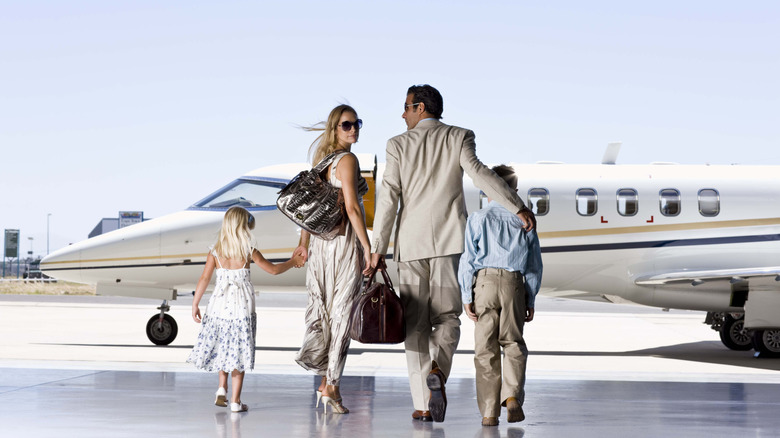 Family boarding a private jet.