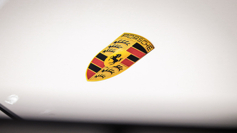 Porsche logo on hood of car