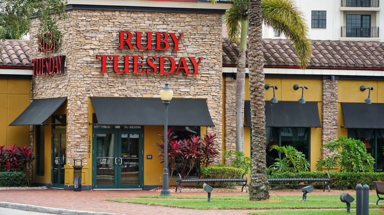A Ruby Tuesday restaurant during the day near a palm tree