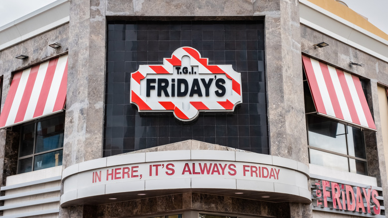 Shot of the TGI Fridays restaurant with focus on logo and slogan