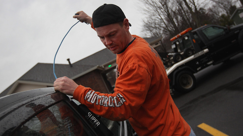 A repo agent seizes a car in Syracuse, New York in 2012 after owner fell behind in payments.