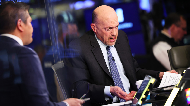 Jim Cramer talks to a CNBC colleague at the New York Stock Exchange