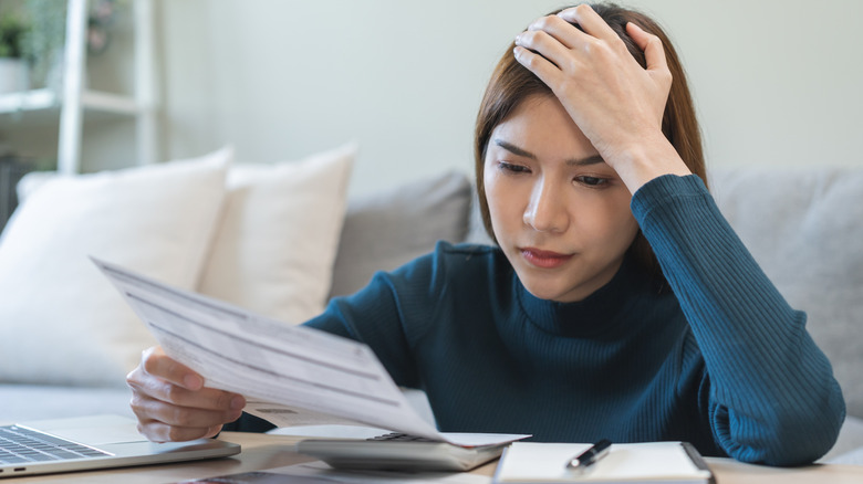 Woman upset going through finances
