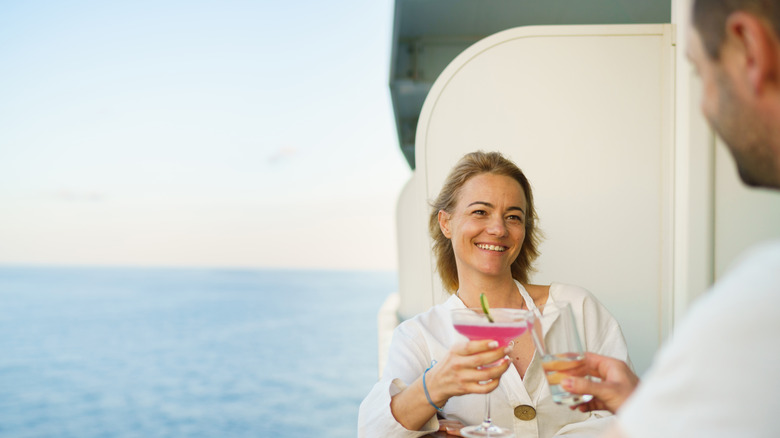 Happy couple having a drink on a cruise ship