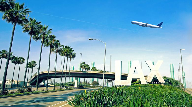 Jet flying over the entrance of LAX airport