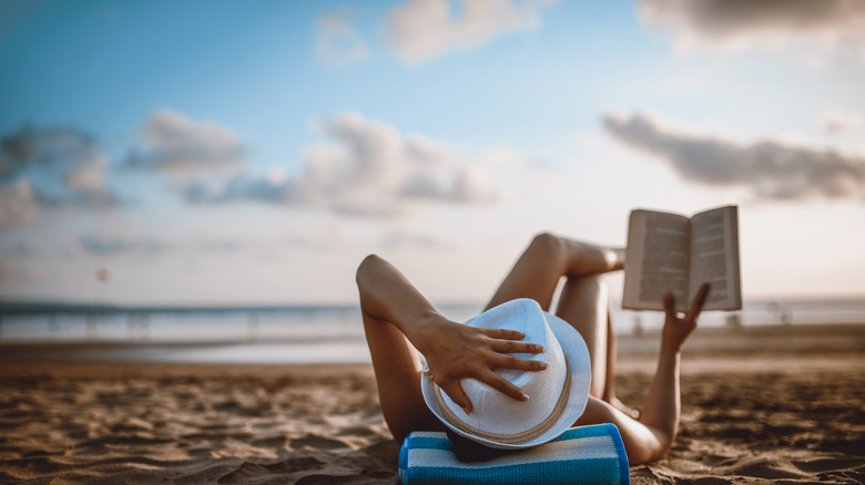 Woman is reading on a beautiful beach