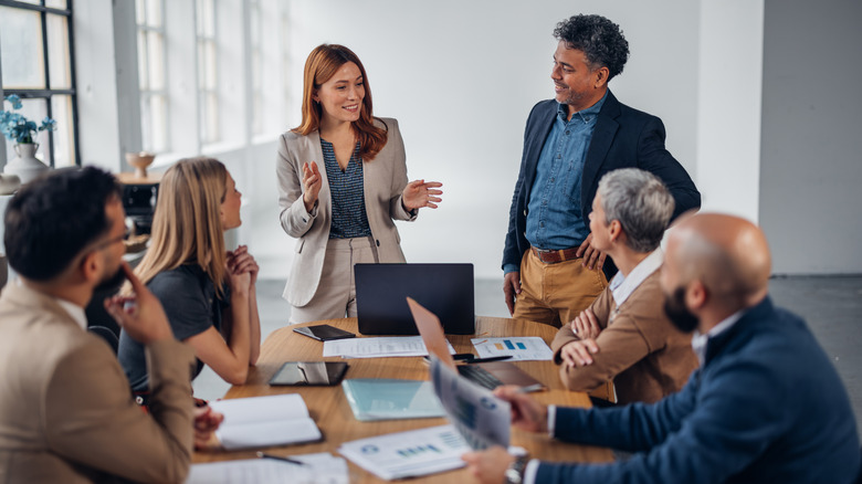 A group of office workers sitting around a table