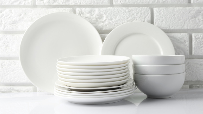 Stacks of ceramic bowls and dishes on a counter