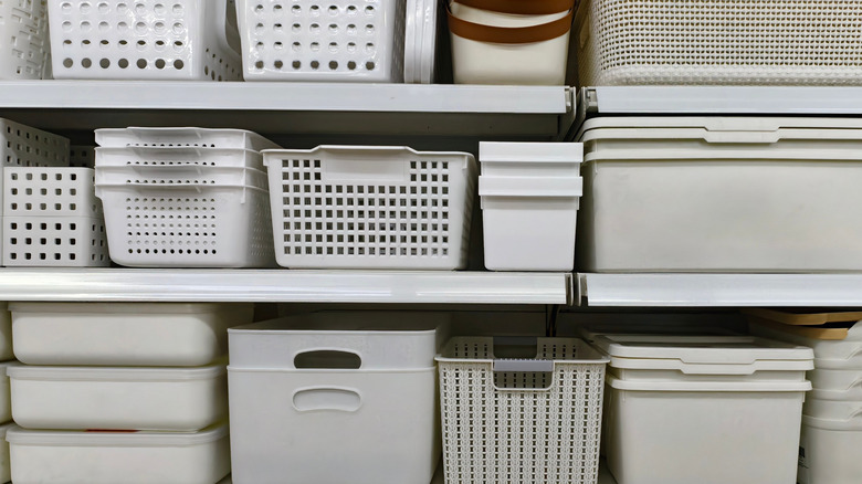 Various stacks of storage bins and organizers on a store shelf