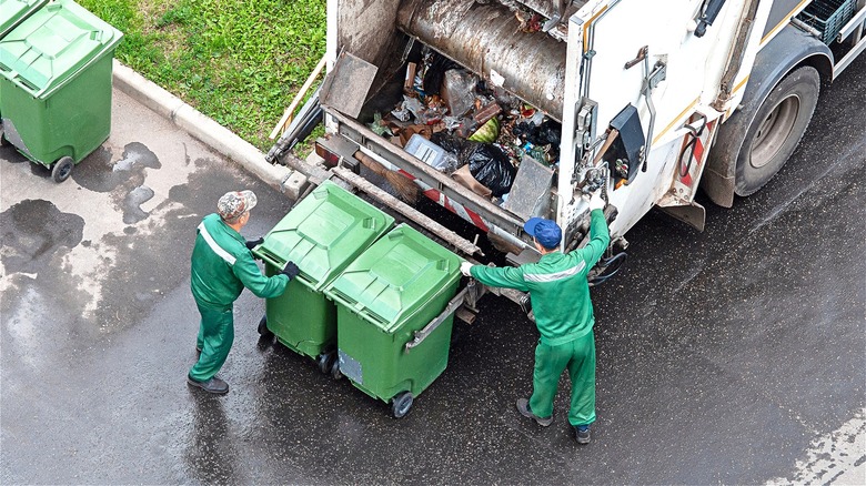 Garbage collectors loading a truck