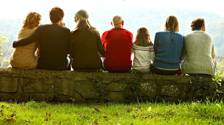 Multigenerational family sitting outside