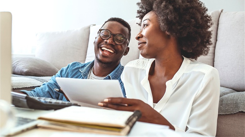 Couple smiling while discussing finances