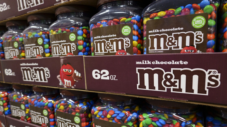 Closeup of a rack of bulk M&M's containers