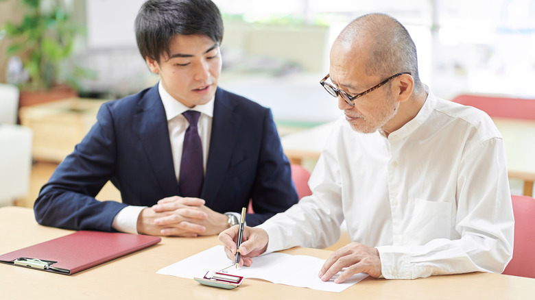 People discussing a document