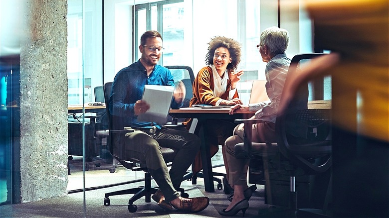 Different generations having office meeting