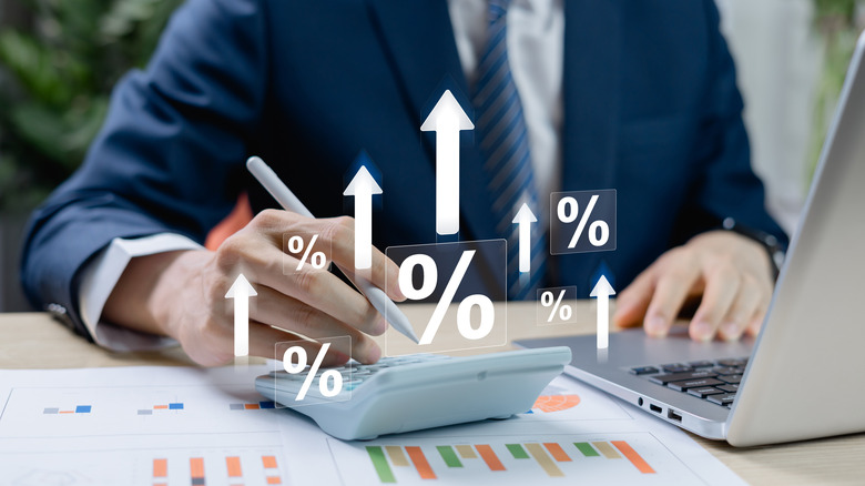 Investor calculating profits on his laptop