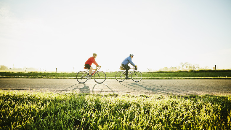 Two people people riding bikes on sunny day
