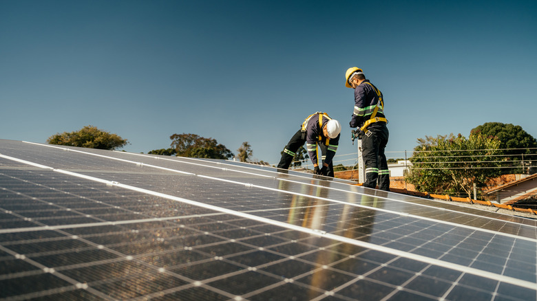 workers installing solar panels