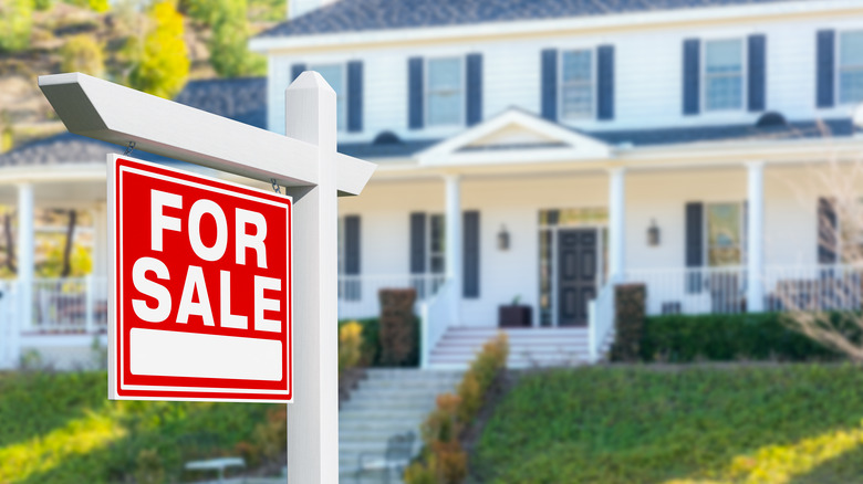 for sale sign in front of house
