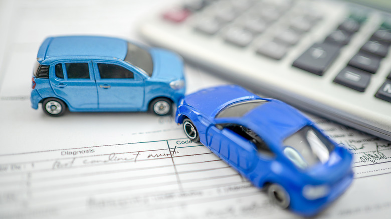 Toy cars next to calculator