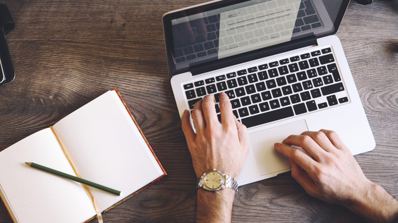 writing a book on laptop
